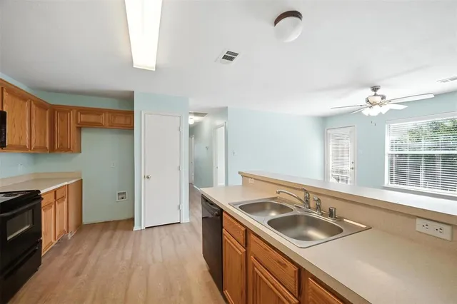 a kitchen with sink stove and refrigerator