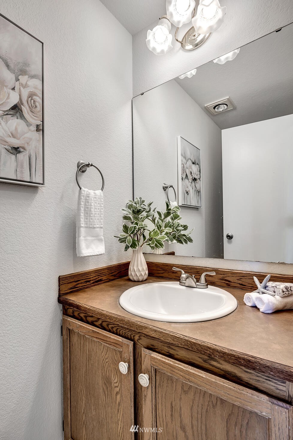 23413 12th Place West Bothell, WA 98021 - Photo 15 of 39 a sink with a mirror and vanity