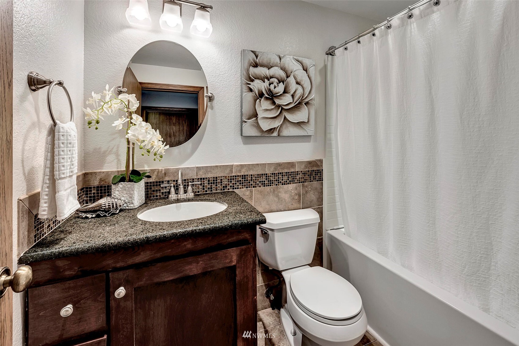 23413 12th Place West Bothell, WA 98021 - Photo 25 of 39 a bathroom with a granite countertop toilet sink and mirror