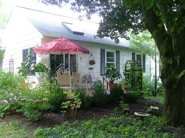 21 Interlaken Road Stockbridge, MA 01266 - Photo 12 of 16 a front view of a house with a porch and garden