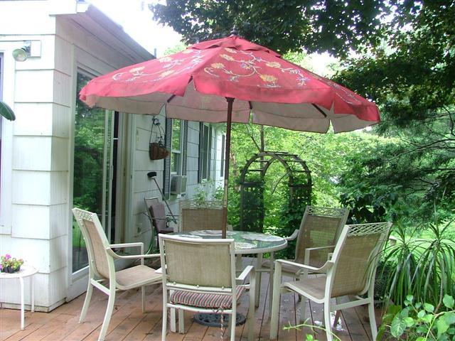 21 Interlaken Road Stockbridge, MA 01266 - Photo 4 of 16 a patio with a patio table and chairs