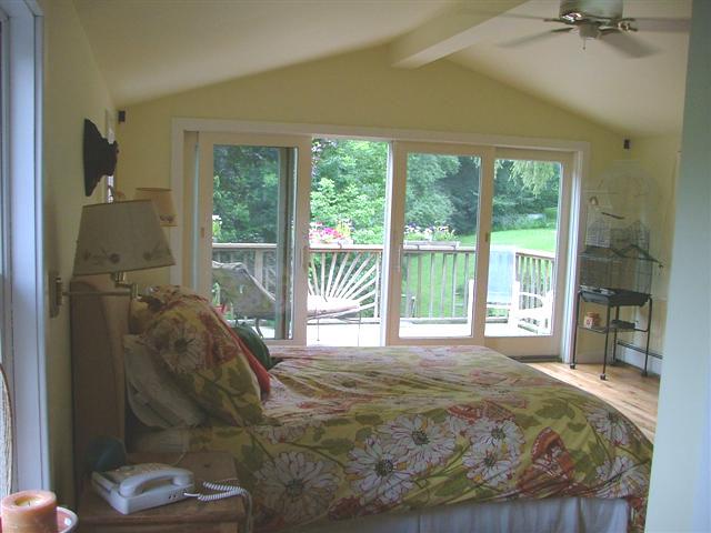 21 Interlaken Road Stockbridge, MA 01266 - Photo 9 of 16 a bed sitting in a bedroom next to a large window