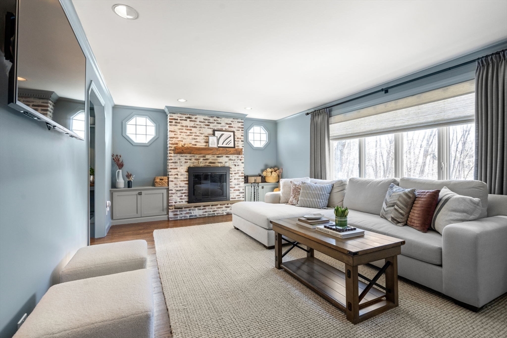 4 Stevens Road Wellesley, MA 02482 - Photo 21 of 39 a living room with furniture a fireplace and a flat screen tv