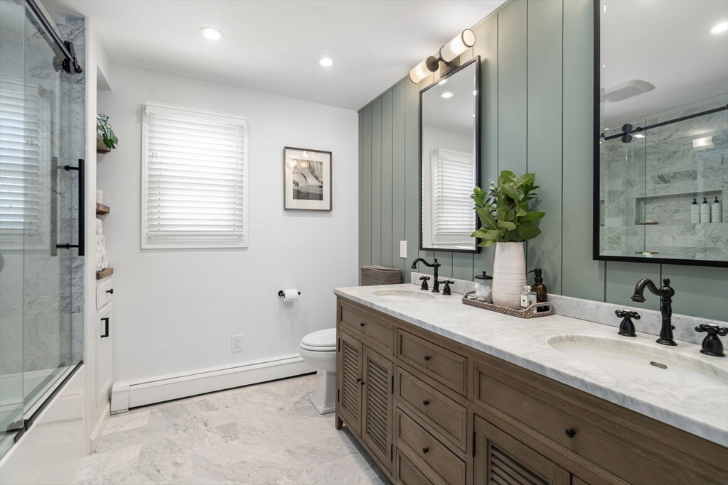 4 Stevens Road Wellesley, MA 02482 - Photo 30 of 39 a bathroom with a double vanity sink toilet and mirror