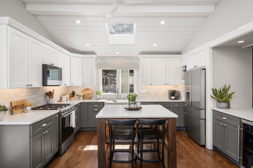 4 Stevens Road Wellesley, MA 02482 - Photo 5 of 39 a kitchen with a table chairs stove and cabinets