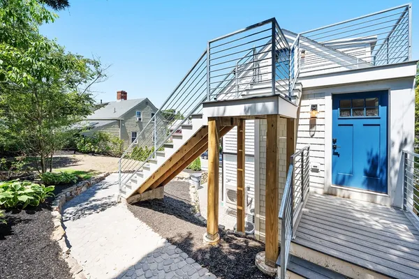 a view of a house with backyard and deck