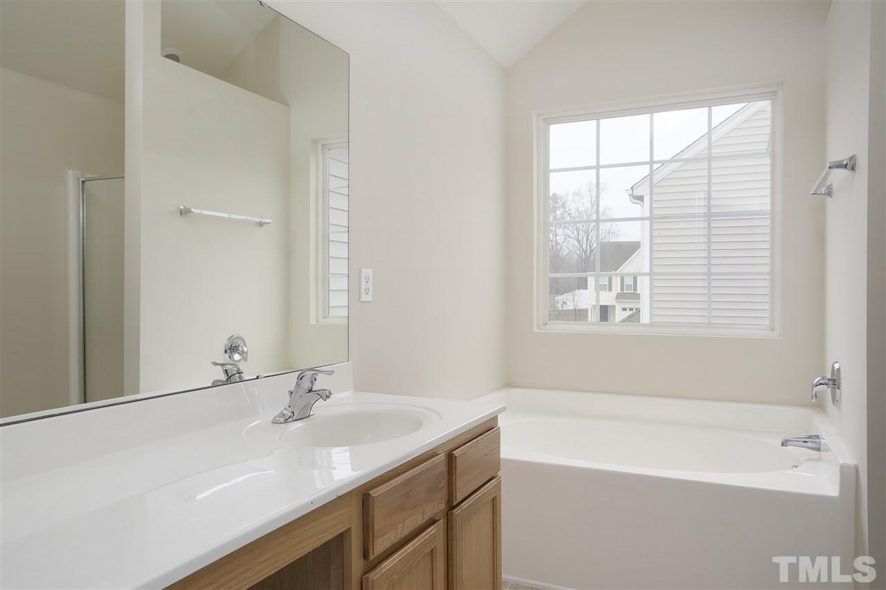 1112 Lombar Street Raleigh, NC 27610 - Photo 11 of 19 a bathroom with a tub sink and mirror