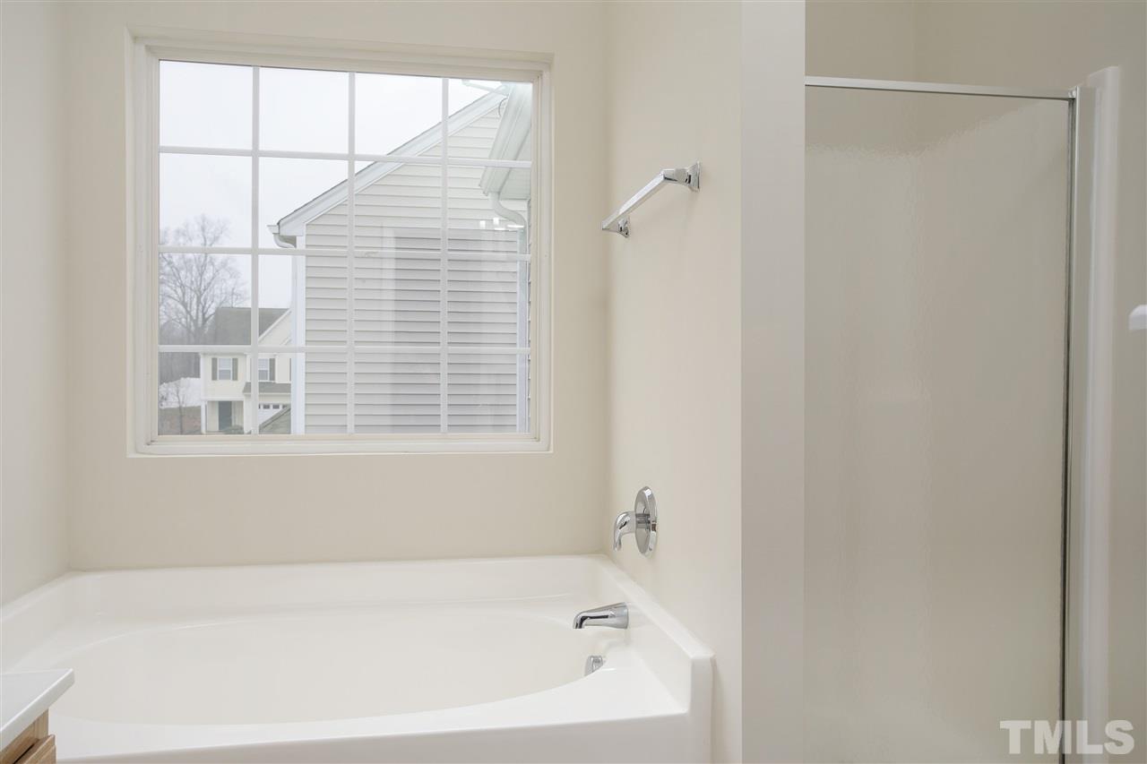 1112 Lombar Street Raleigh, NC 27610 - Photo 12 of 19 a white bath tub sitting next to a window