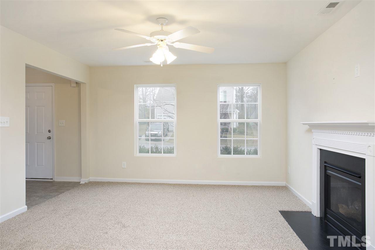 1112 Lombar Street Raleigh, NC 27610 - Photo 4 of 19 a view of an empty room with a fireplace and a window