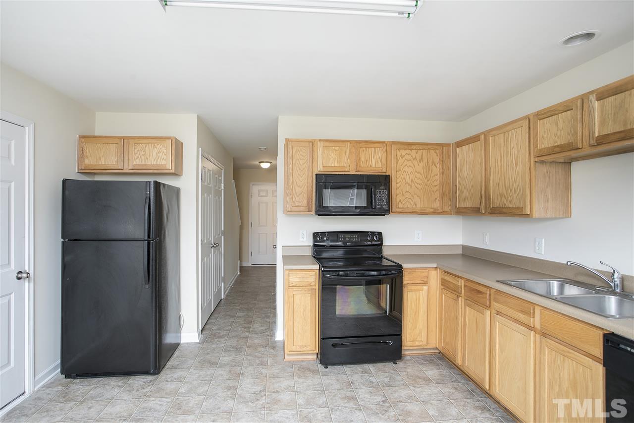 1112 Lombar Street Raleigh, NC 27610 - Photo 6 of 19 a kitchen with stainless steel appliances granite countertop a refrigerator stove and sink