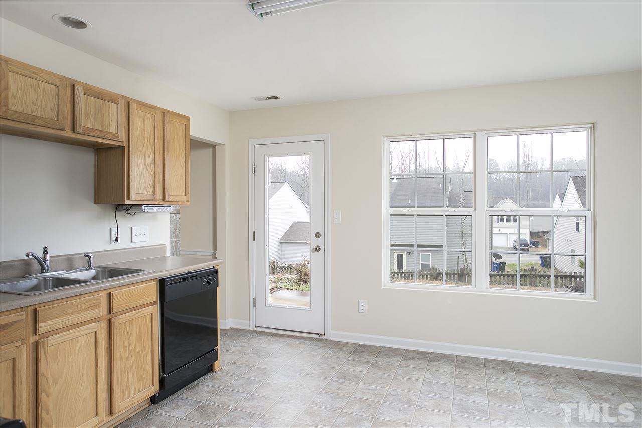 1112 Lombar Street Raleigh, NC 27610 - Photo 8 of 19 a kitchen with a sink cabinets and window
