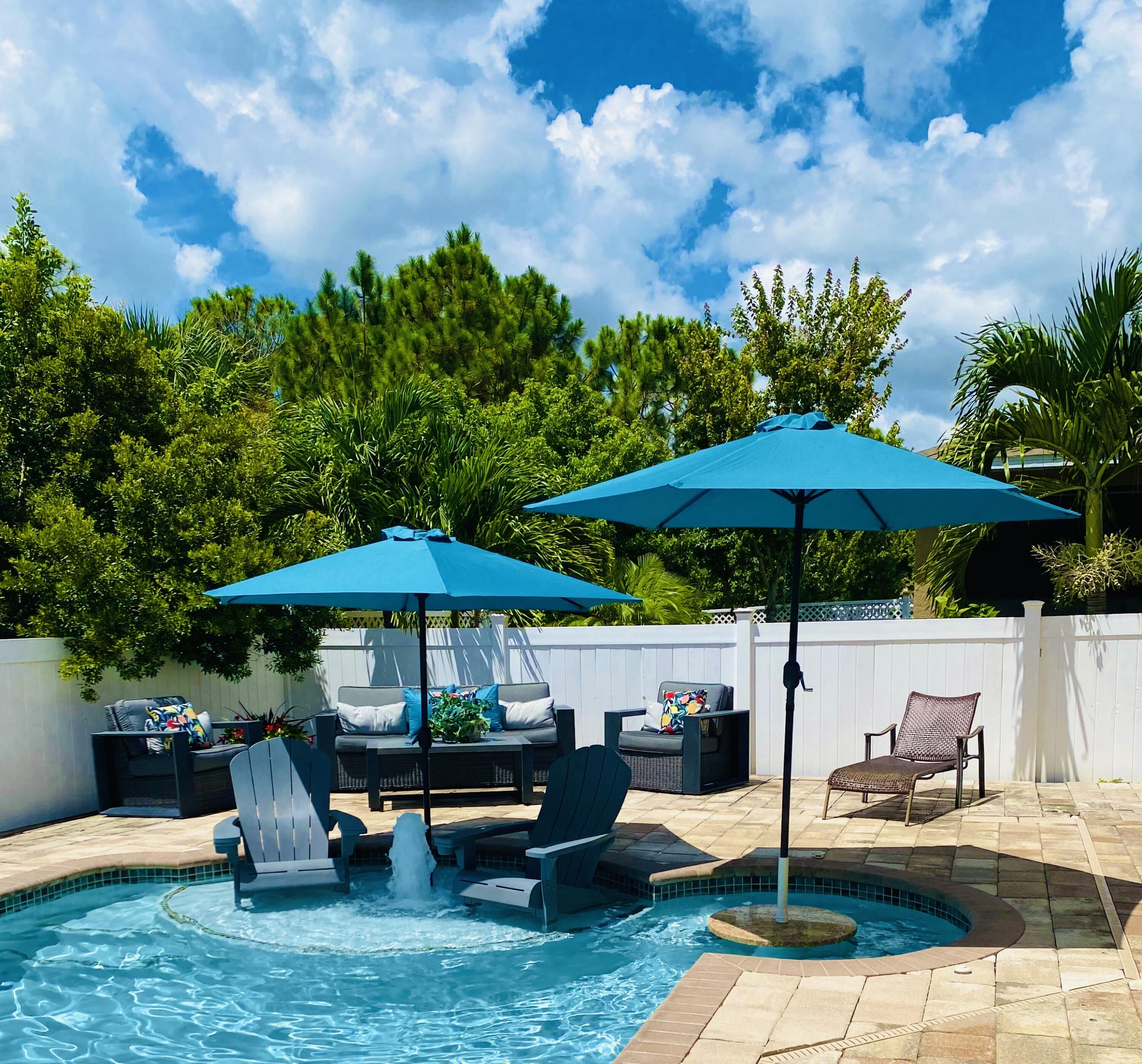 5380 Northwest Wisk Fern Circle Port St. Lucie, FL 34986 - Photo 1 of 36 a view of a house with backyard sitting area and garden