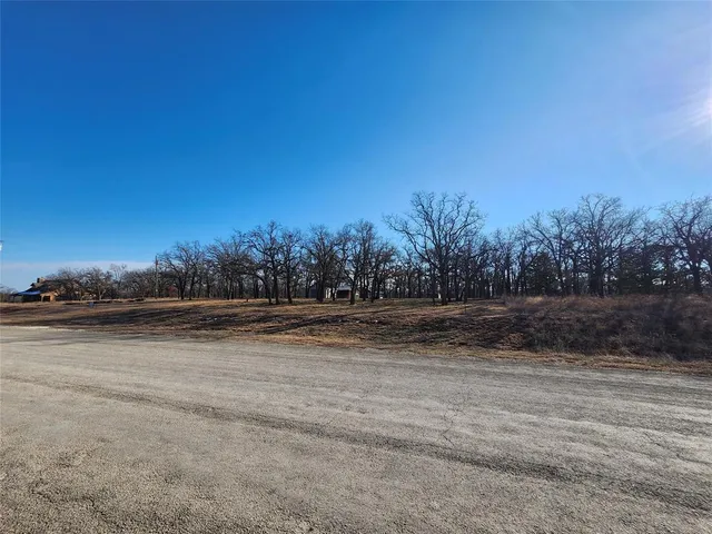 an aerial view of ocean and residential houses with outdoor space