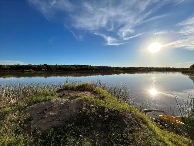 a view of a lake with houses in the back