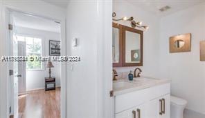 19 Whitehead Circle Weston, FL 33326 - Photo 2 of 6 a bathroom with a sink and a mirror