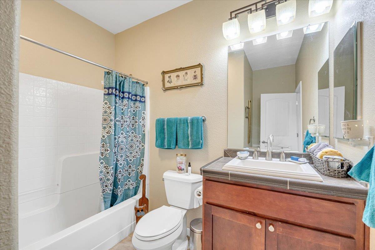 411 Sunrise Road Copperopolis, CA 95228 - Photo 46 of 76 Guest bath with the same lovely counter and cabinetry and a shower over tub.