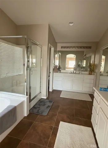 a bathroom with a glass shower door and a sink
