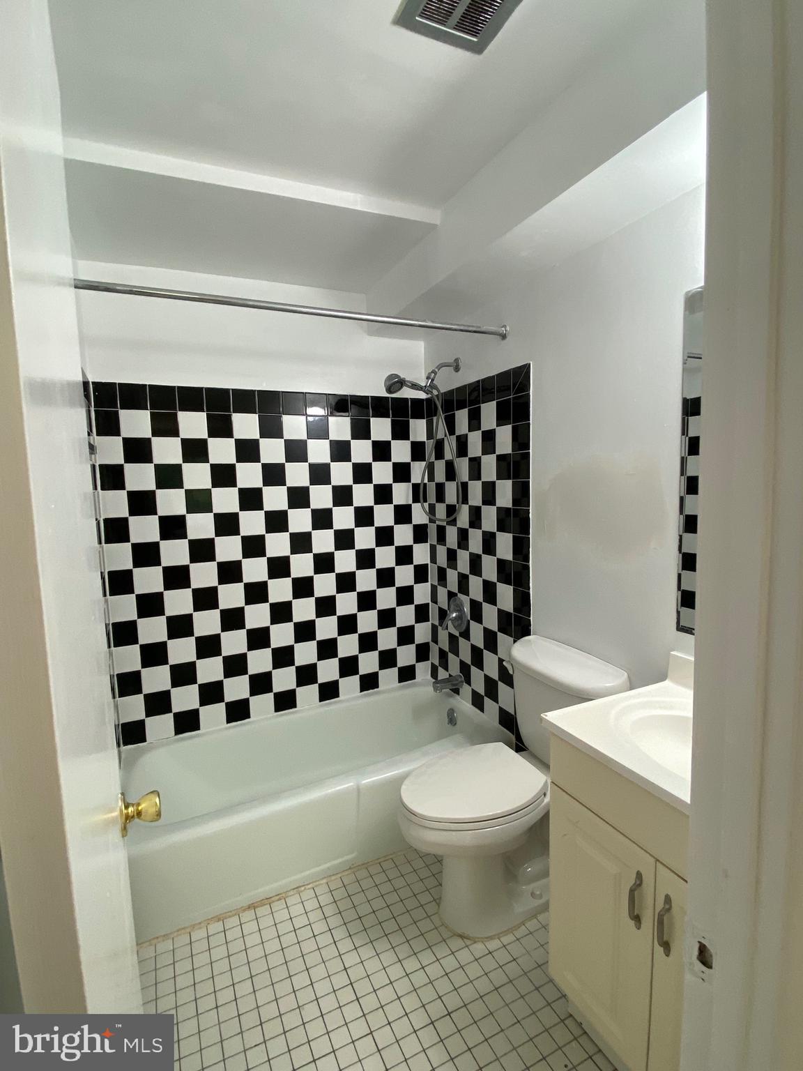 322 West Deer Park Road, Unit 2C Gaithersburg, MD 20877 - Photo 18 of 32 a bathroom with a black and white checkered floor