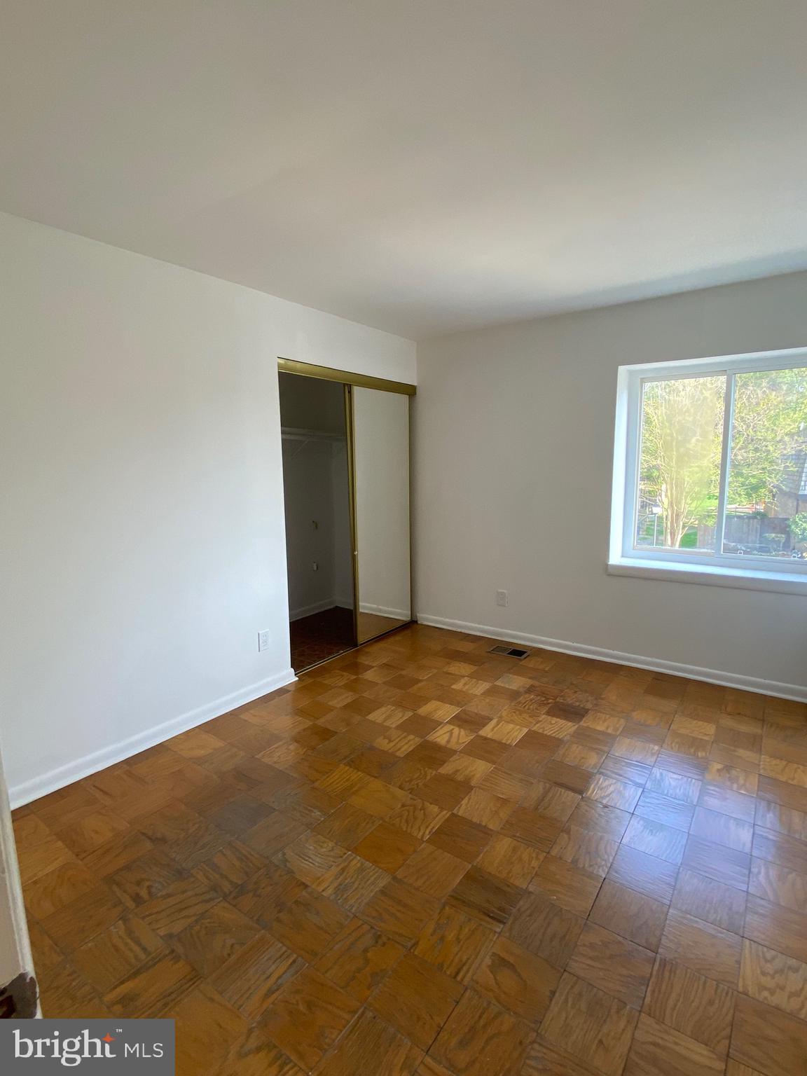 322 West Deer Park Road, Unit 2C Gaithersburg, MD 20877 - Photo 19 of 32 an empty room with wooden floor and windows