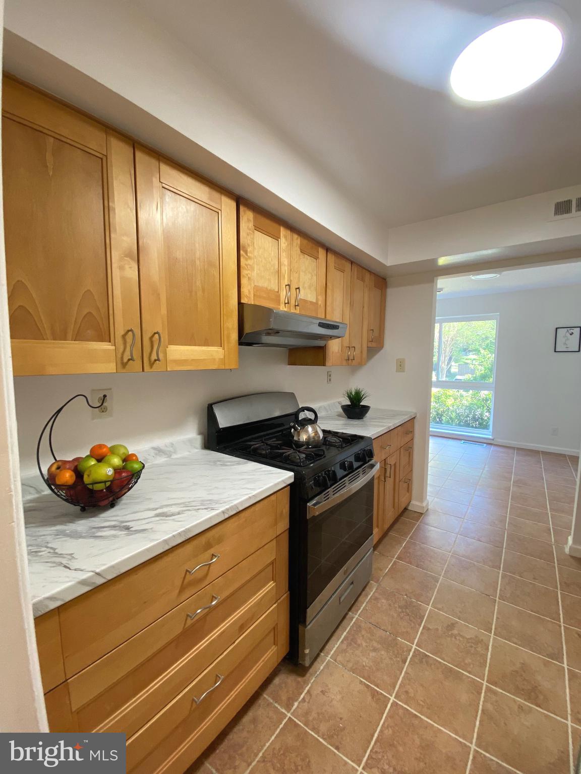 322 West Deer Park Road, Unit 2C Gaithersburg, MD 20877 - Photo 25 of 32 a kitchen with a stove a sink and a window
