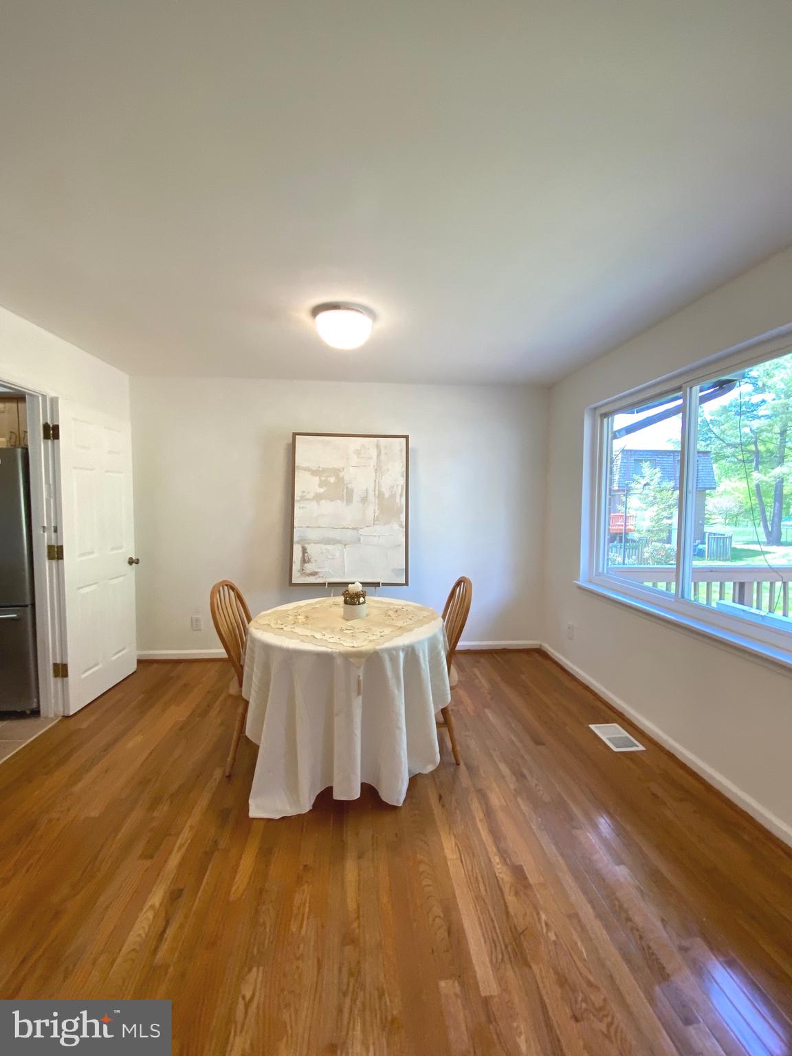 322 West Deer Park Road, Unit 2C Gaithersburg, MD 20877 - Photo 7 of 32 a living room with a table and a window