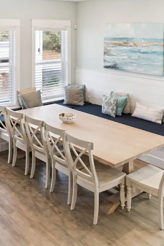 a kitchen with stainless steel appliances kitchen island granite countertop a kitchen island and chairs in it