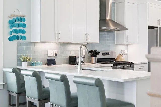 a kitchen with a stove a sink and cabinets