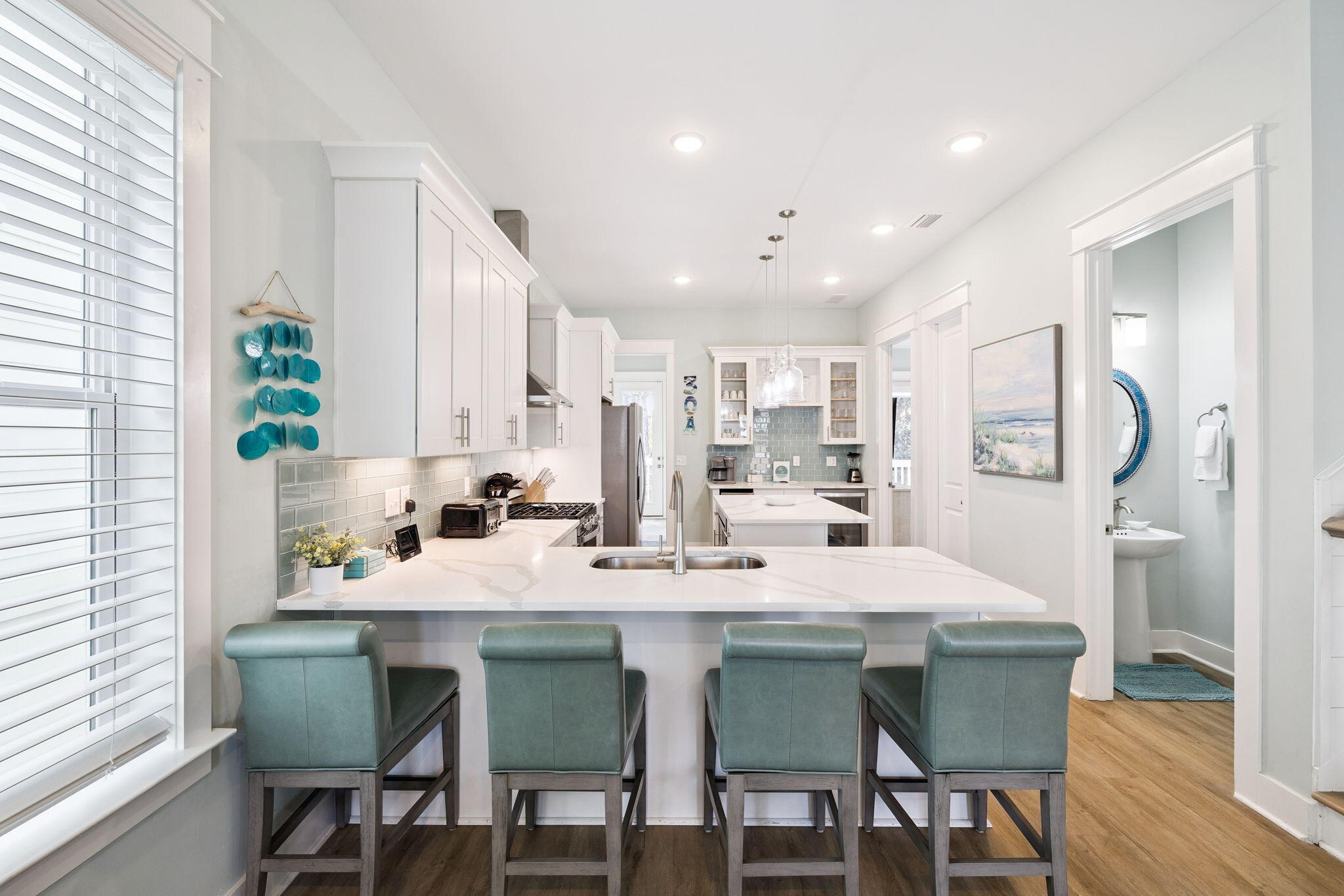 345 Dolphin Drive Santa Rosa Beach, FL 32459 - Photo 16 of 73 a kitchen with stainless steel appliances kitchen island granite countertop a kitchen island and chairs in it