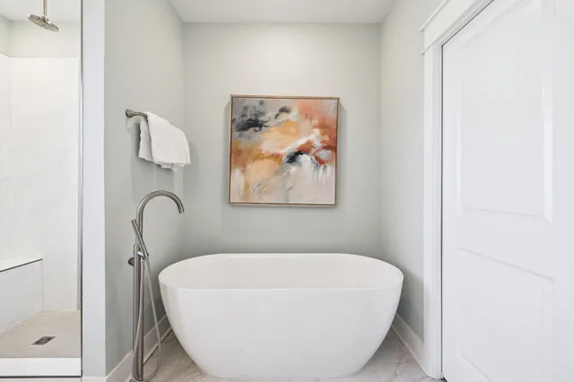 a living room with furniture a flat screen tv and kitchen view