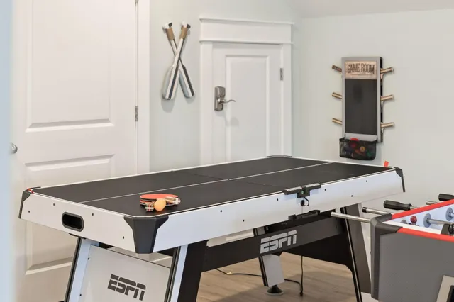 an aerial view of a house with swimming pool and large trees