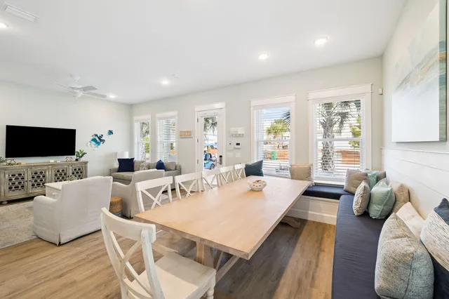 a kitchen with stainless steel appliances granite countertop a sink a stove and white cabinets