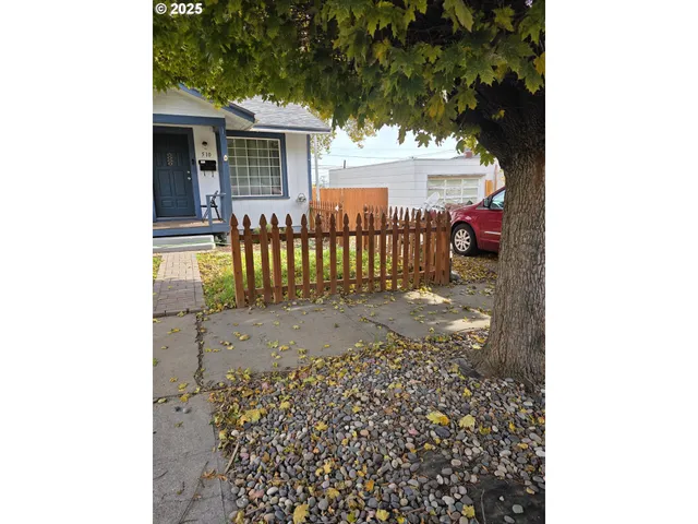 a view of a porch with a bench in front of house