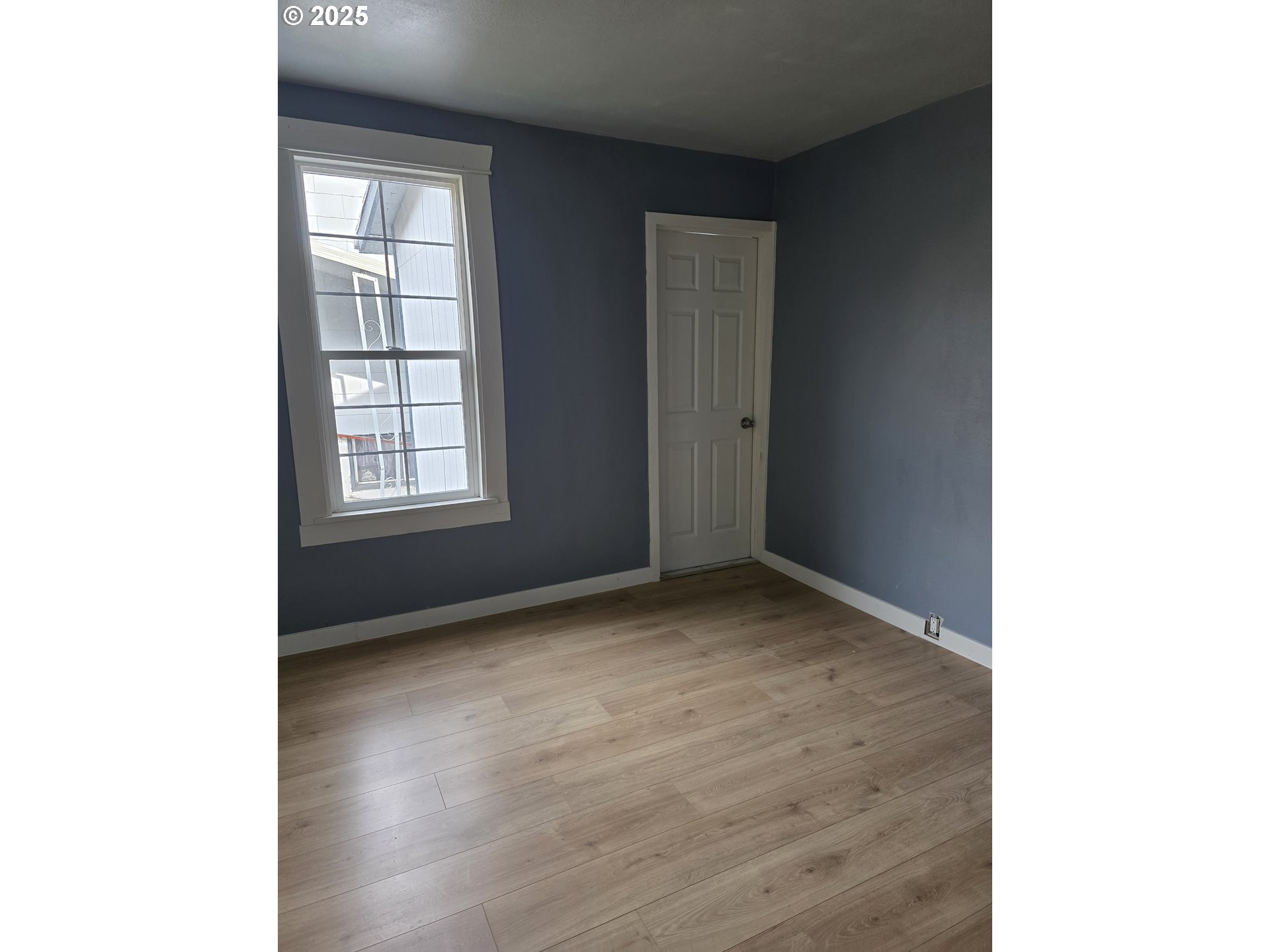 510 Northwest 11th Street Pendleton, OR 97801 - Photo 6 of 20 a view of an empty room with wooden floor and a window