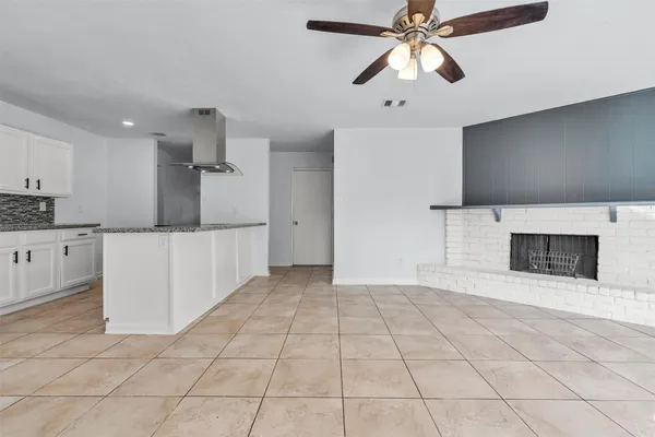 a view of a kitchen with an empty space and a fireplace