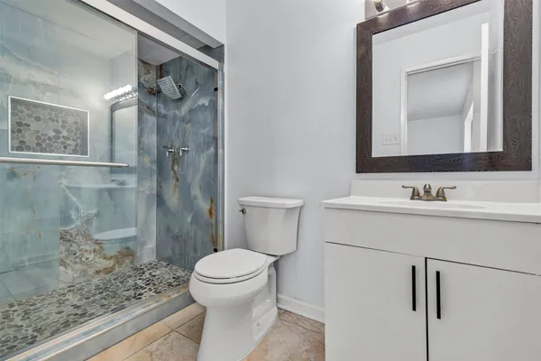 a bathroom with a sink toilet and shower