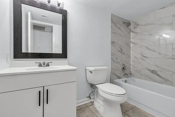 a bathroom with a sink toilet vanity and shower