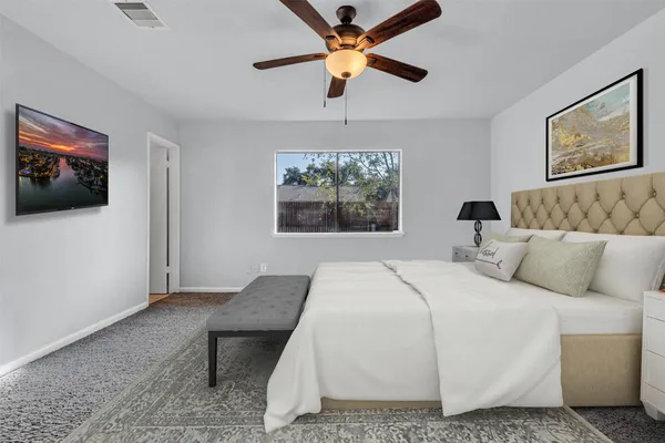 a bedroom with a bed and a chandelier