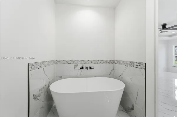 a white bath tub sitting in a bathroom