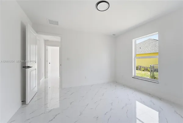 a view of an empty room with a window