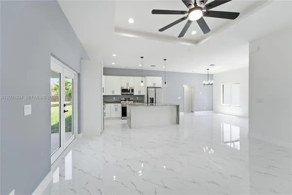 a view of a kitchen with a refrigerator and microwave