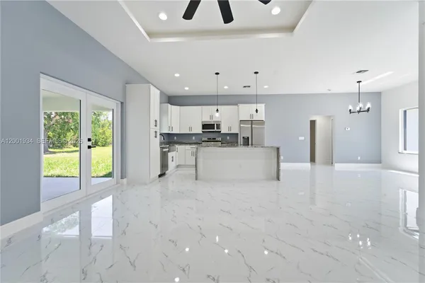 a large white kitchen with a large window