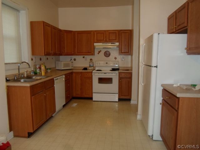 1312 Decatur Street Richmond, VA 23224 - Photo 3 of 7 a kitchen with stainless steel appliances granite countertop a stove a refrigerator and a sink