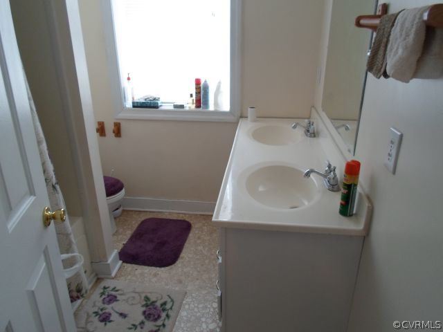 1312 Decatur Street Richmond, VA 23224 - Photo 4 of 7 a bathroom with a sink and mirror