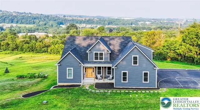 a view of a house with a yard porch and sitting area