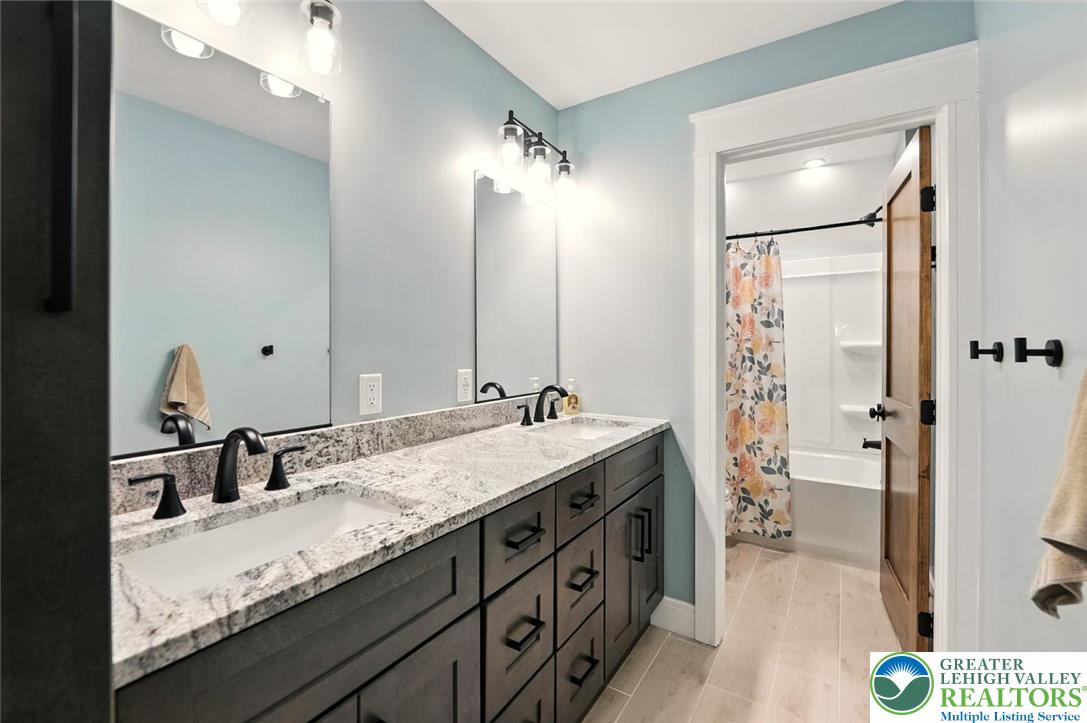 4733 Egypt Road Coplay, PA 18037 - Photo 18 of 40 a bathroom with a granite countertop sink and a mirror