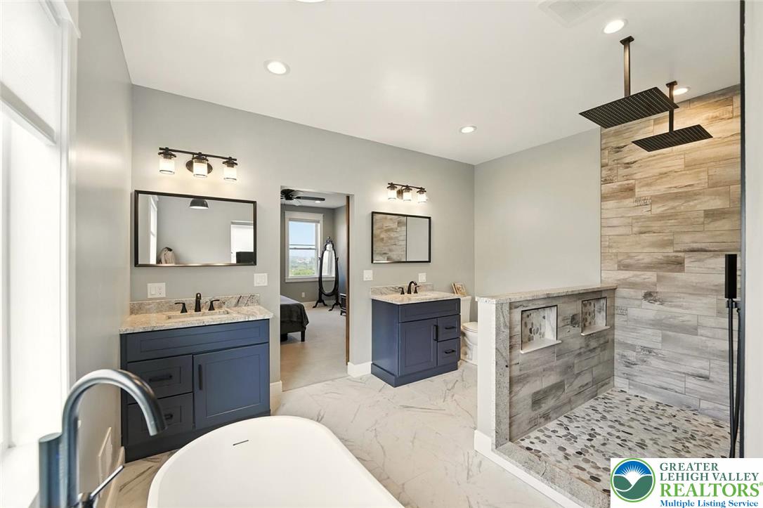 4733 Egypt Road Coplay, PA 18037 - Photo 7 of 40 a bathroom with a sink a large mirror and a shower