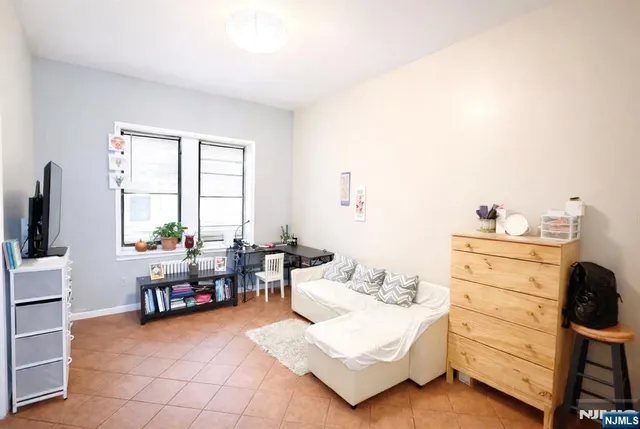 a bedroom with furniture and a large window