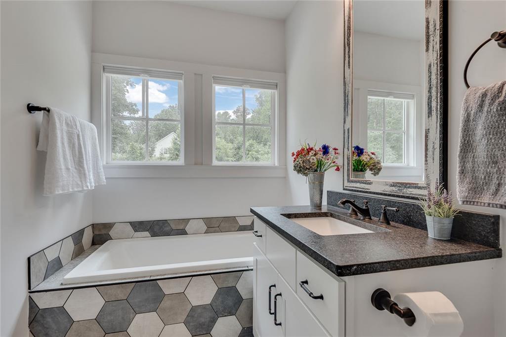 2503 Sugar Pike Road Canton, GA 30115 - Photo 104 of 134 a bathroom with a granite countertop sink and a mirror