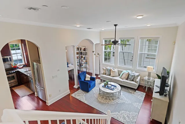 a living room with furniture and wooden floor