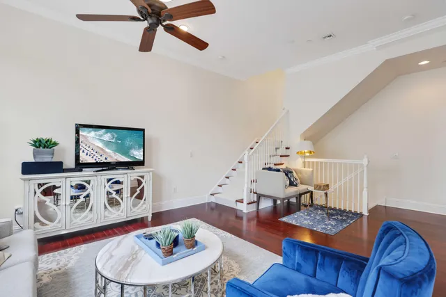 a living room with furniture and a wooden floor